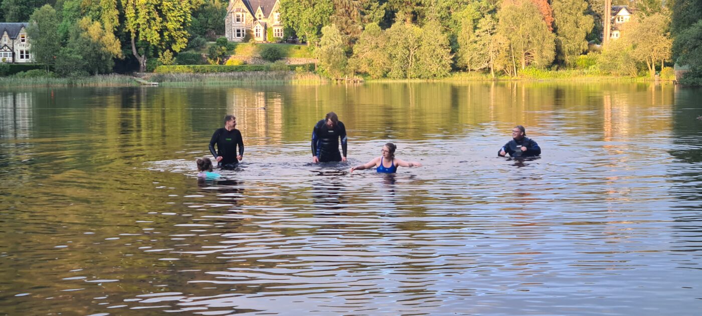 People dipping in a loch